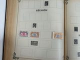 an open book with stamps on it sitting on a table
