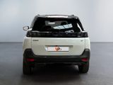 a small white car that is parked in a room