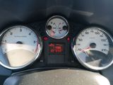 a close up of a car dashboard with gauges and speedometers
