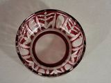 a red and white bowl on a white table