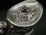 a close up of a silver object on a glass table