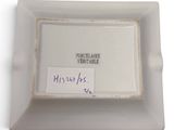 a picture of a white plate with a label on it
