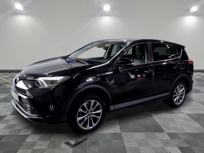the black toyota rav is parked in a large room