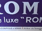 a sign that says rome in white on a purple background