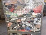 a metal cart with many items in it in a warehouse