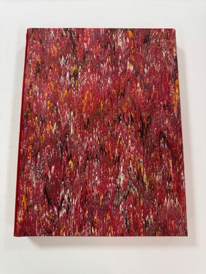 an abstract painting of red and black paint on a white surface