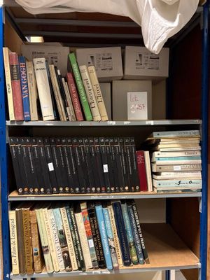 a book shelf with many books on it in a room