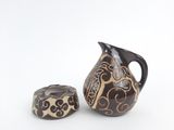 a brown and black vase and a black and white vase