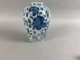 a blue and white vase sitting on a table