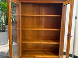 a wooden cabinet with a door open on a tiled floor