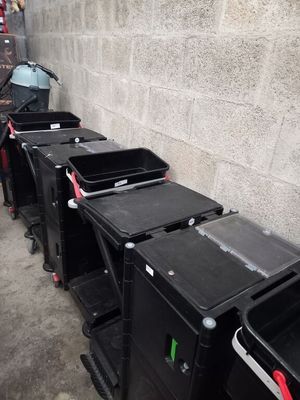 a lot of trash cans lined up on the side of the street
