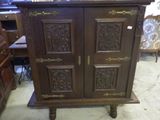 a wooden cabinet that is sitting in the middle of a room