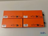 three boxes of orange boxes sitting on top of a white table