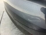 a close up of a car ' s bumper with scratches on it