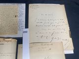 several old papers are on display on a black table