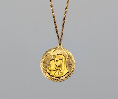 a gold necklace with a picture of a woman on it
