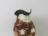a ceramic figurine of a man with a hat on