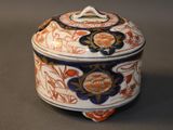 a small box with a lid that has a flower design on it