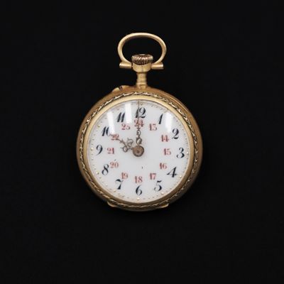 an antique pocket watch on a black background with a black background