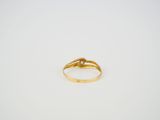 a close up of a gold ring on a white surface