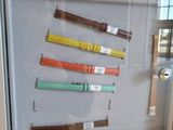 a picture of a display case with different colored watches