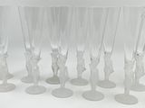 six clear wine glasses with figures on them sitting on a white surface