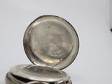 a small silver box with a silver lid on a table