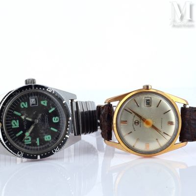 two watches sitting next to each other on a white surface
