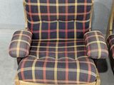 pair of plaid upholstered chairs with wooden legs