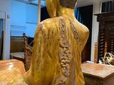 a statue of a person sitting on a table