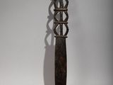 a knife that is hanging on a white wall
