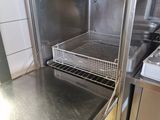 a stainless steel oven with a basket inside of it