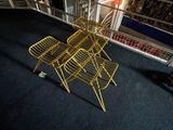 a cat that is standing next to a yellow chair