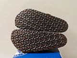 the bottom of a pair of shoes on top of a blue box