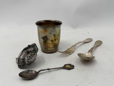 a cup, spoon, and spoon rest on a table