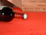 a bottle of wine sitting on a table next to a wooden box