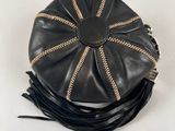 black leather purse with gold zippers on a white background