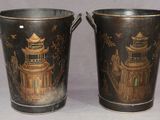 two metal buckets with asian designs on them