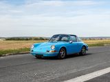 a blue car that is driving down the road
