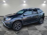 a grey dacia is parked in a room with a checkered floor