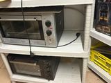 two microwaves and a toaster oven on a shelf