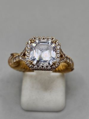 a close up of a diamond ring on a white surface