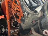 an image of a chainsaw in a garage with other tools