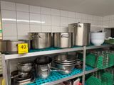 many pots and pans on the shelves in the kitchen