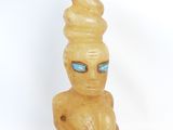 a small statue of a man with a cone on his head