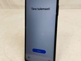 a close up of a cell phone on a table with a message on the screen
