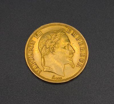 a close up of a gold coin on a black surface