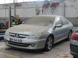 a silver car parked in a garage next to other cars