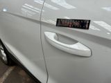 a close up of a car door handle with a sticker on it