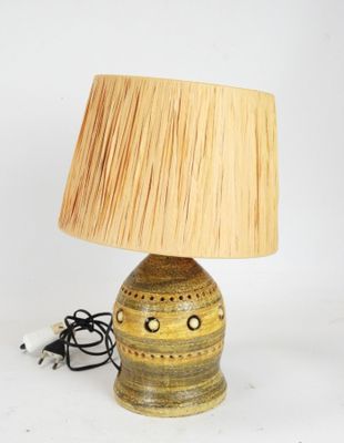 a lamp that is sitting on a table with a lamp shade on it